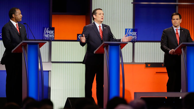 Republican presidential candidate Sen. Ted Cruz R-Texas center answers a question as retired neurosurgeon Ben Carson left and Sen. Marco Rubio R-Fla. right listen during a Republican presidential primary debate Thursday Jan. 28 2016 in Des Moi