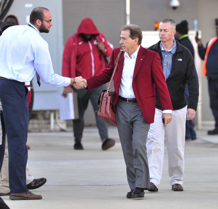 Alabama coach Nick Saban shakes hands as the football team arrives at an airport Tuesday Jan. 12 2016 in Birmingham Ala. Alabama defeated Clemson on Monday night for the College Football Playoff championship