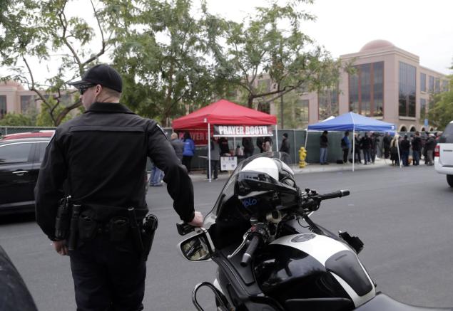 Law enforcement officers guard the Inland Regional Center in San Bernardino Calif. Monday as workers return to the center