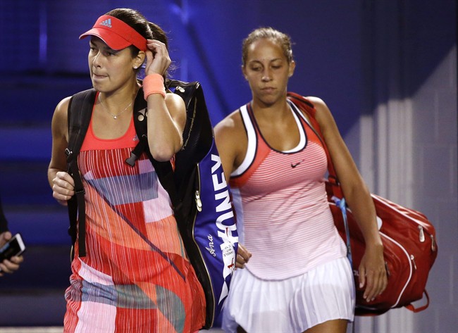 Ana Ivanovic left of Serbia and Madison Keys of the United States walk back onto Rod Laver Arena after play was suspended for just under an hour due to a medical emergency in the crowd during their third round match at the Australian Open tennis champio