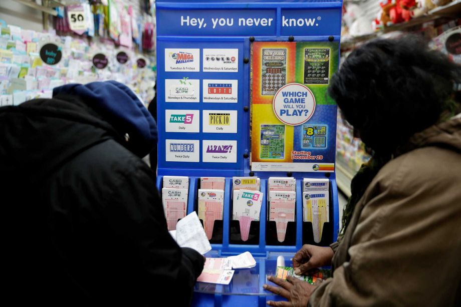 People play various lottery games at a store in New York Monday Jan. 11 2016. Lottery officials say the Powerball jackpot has grown to more than a billion dollars