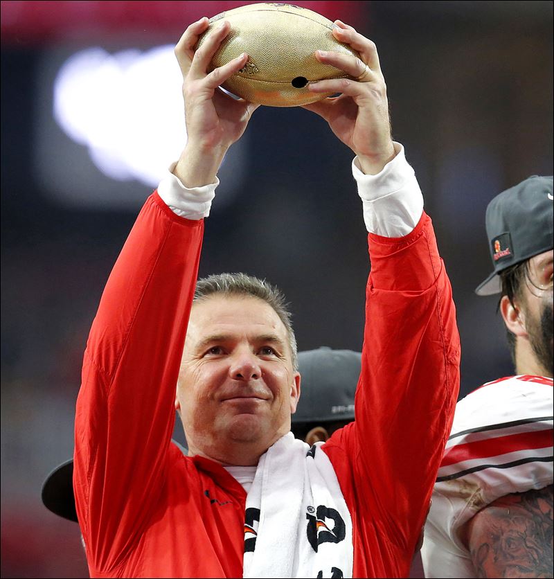 Ohio State head coach Urban Meyer raises the trophy after their 44-28 win over Notre Dame in the Fiesta Bowl