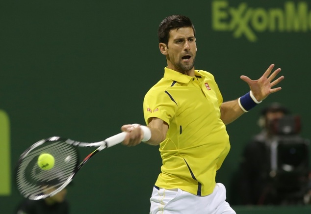 Novak Djokovic returns the ball to Rafael Nadal during the final of the Qatar Open in Doha