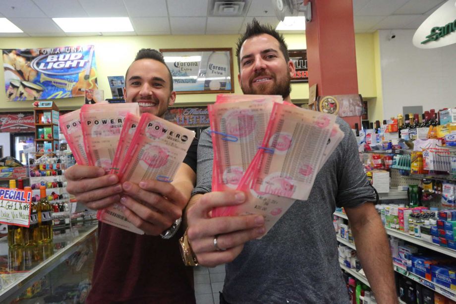 Ryan McGuinness left and Shane Krugman display 3,000 Powerball lottery tickets that they had purchased from the Metro Market Wednesday Jan. 13 2016 in Tampa. The two Tampa men have organized a lottery pool that has about 270 participants who have