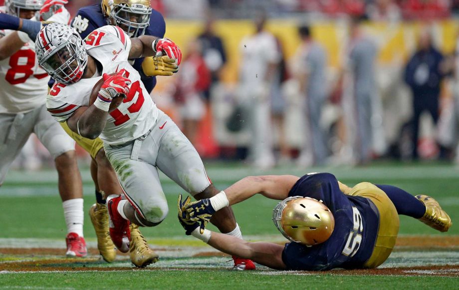 Ohio State running back Ezekiel Elliott gets past Notre Dame linebacker Jarrett Grace in the third quarter during the Battlefrog Fiesta Bowl at the University of Phoenix Stadium in Glendale Ariz. on Friday Jan. 1 2016. Ohio State won 44-28