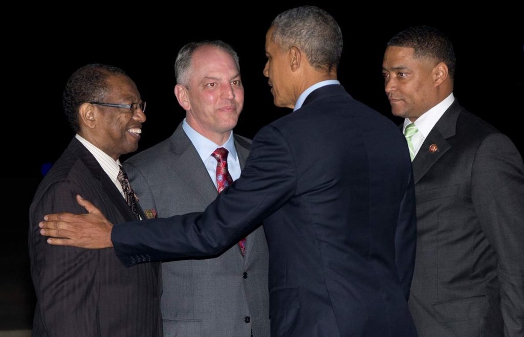 President Barack Obama is greeted by from left Kip Holden Mayor President of East Baton Rouge Parish left and Louisiana Gov. John Bel Edwards as he arrives on Air Force One at Baton Rouge Metropolitan Airport in Baton Rouge La. Wednesday Jan. 13