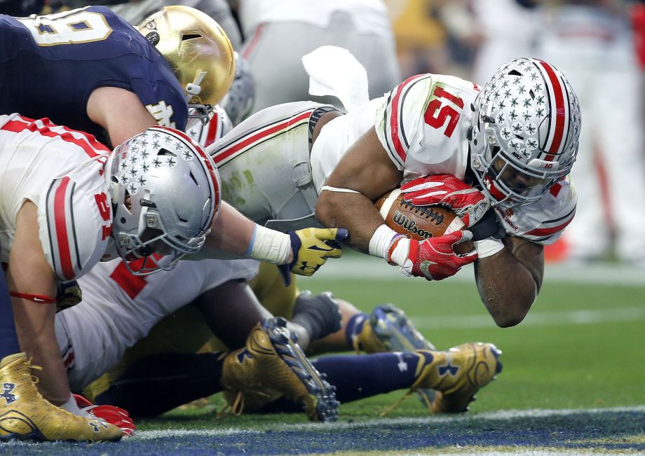 Ohio State running back Ezekiel Elliott dives for one of his four touchdowns in the Buckeyes’ win over Notre Dame