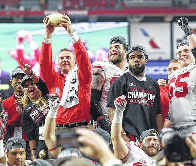 Ohio State head football coach Urban Meyer celebrates the team's Fiesta Bowl win with his players