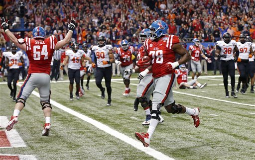 Mississippi offensive lineman Laremy Tunsil carries for a touchdown in the first half of the Sugar Bowl college football game against Oklahoma State in New Orleans Friday Jan. 1 2016