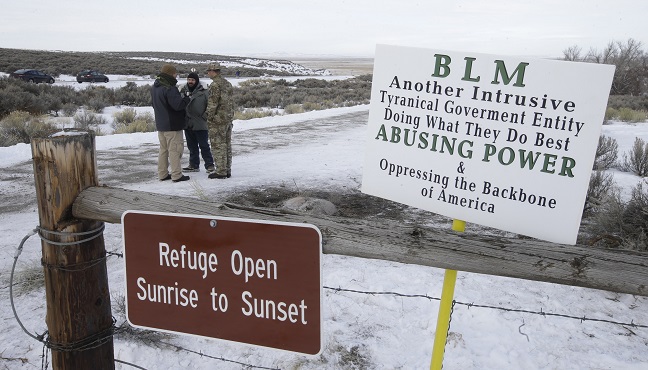 Members of the group occupying the Malheur National Wildlife Refuge headquarters stand guard Monday Jan. 4 2016 near Burns Ore. The group calls itself Citizens for Constitutional Freedom and has sent a'demand for redress to local state and federal