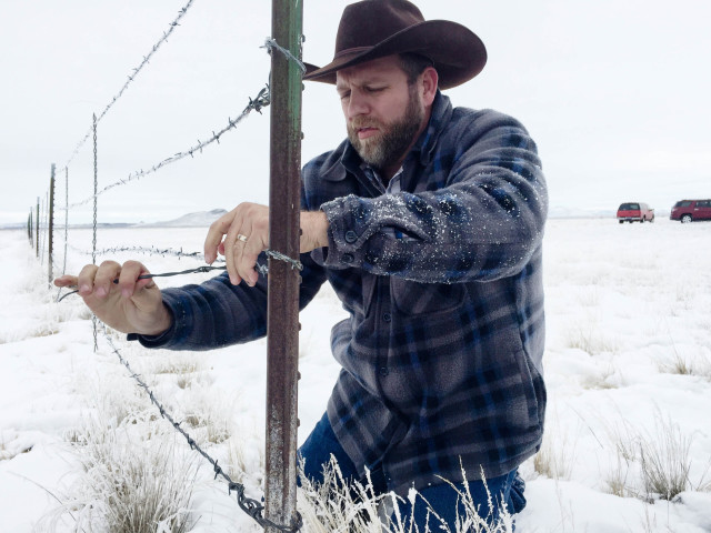 Ammon Bundy works on a stretch of fence at the Malheur National Wildlife Refuge Monday Jan. 11 2016. The militia occupying the refuge since Jan. 2 took down an 80-foot stretch of the fence to open up the lands for cattle grazing from a nearby ranch