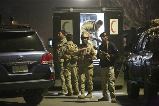 Afghan security forces respond to a car bomb attack by Taliban militants near a foreign guesthouse in Kabul Afghanistan Friday Dec. 11 2015. A Taliban spokesman said a suicide bomber targeted the guesthouse in Shir Pur an area with embassies and othe