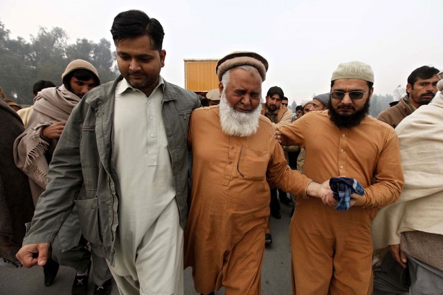 People attend the funeral of Fakhr-e-Alam a worker at Bacha Khan University who was killed in a Taliban attack at the university in Charsadda