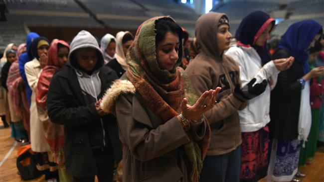 Pakistani women pray for Bacha Khan University victims at a sports complex in Islamabad