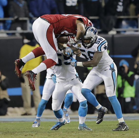 Fells is hit by Carolina Panthers Thomas Davis and Luke Kuechly after catching a pass during the first half the NFL football NFC Championship game Sunday Jan. 24 2016 in Charlotte N.C