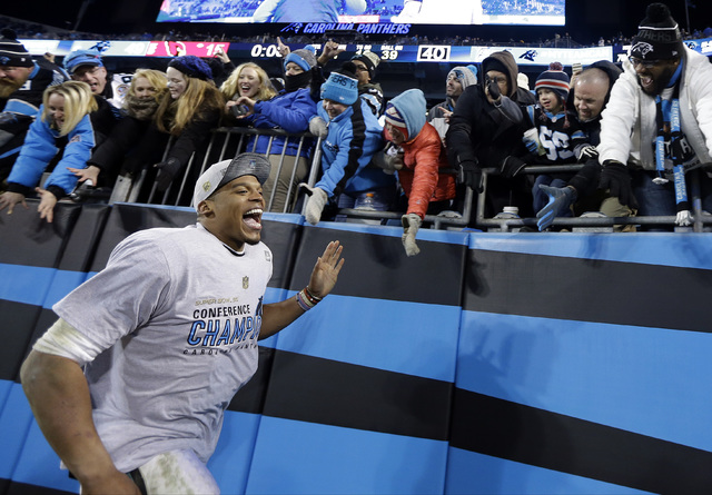 ASSOCIATED PRESS           Carolina Panthers’ Cam Newton celebrates with fans after the NFL football NFC Championship game against the Arizona Cardinals Sunday in Charlotte N.C