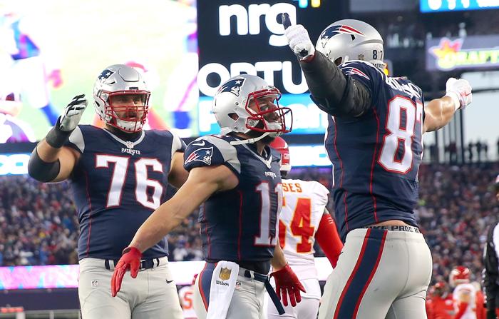 FOXBORO MA- JANUARY 16 Rob Gronkowski #87 of the New England Patriots celebrates a first quarter touchdown with teammates Julian Edelman #11 and Sebastian Vollmer #76 against the Kansas City Chiefs during the AFC Divisional Playoff Game at Gillette Sta