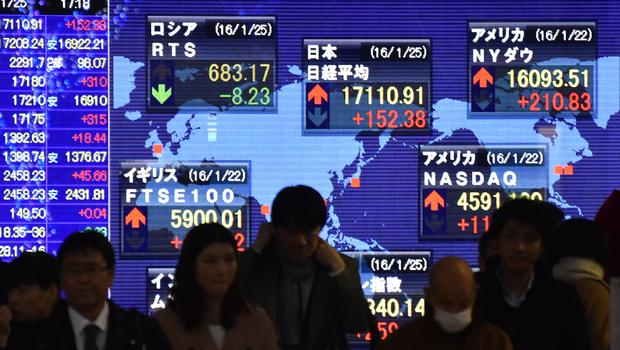 Pedestrians walk past a share prices board in Tokyo on Jan. 25 2016.         
                                     KAZUHIRO NOGI  AFP  Getty Images