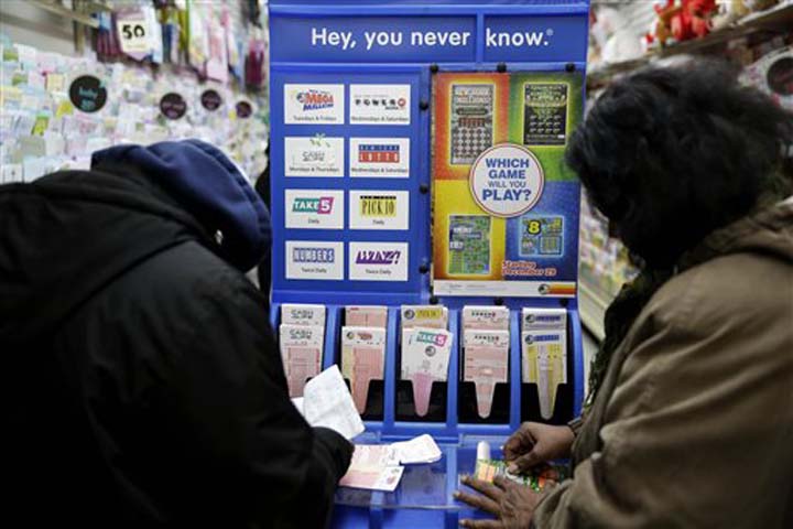 People play various lottery games at a store in New York Monday Jan. 11 2016. Lottery officials say the Powerball jackpot has grown to more than a billion dollars