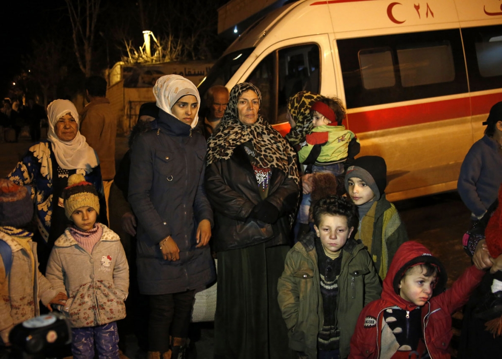 People wait to leave the besieged town of Madaya northwest of Damascus Syria on Monday