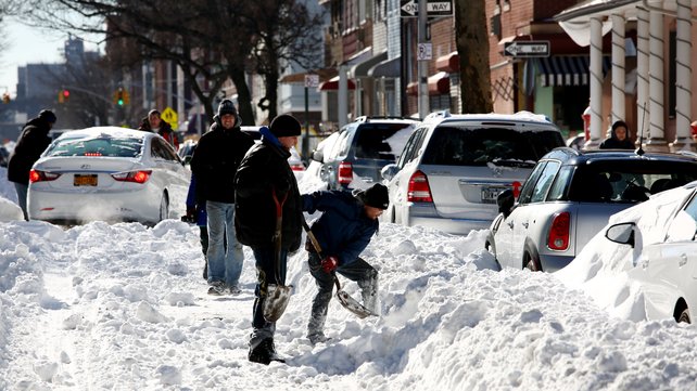 People work on digging out their cars following the snow storm in Brooklyn New York