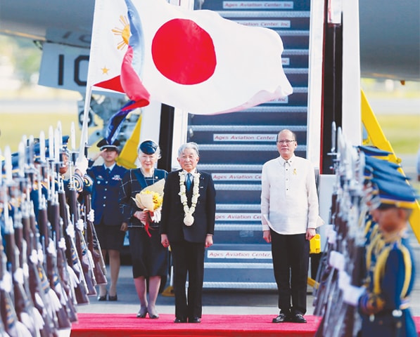 Pasay city: Japan’s Emperor Akihito, Empress Michiko along with Philippine President Benigno Aquino stand in respect of their national anthems played on their arrival here on Tuesday.—AP