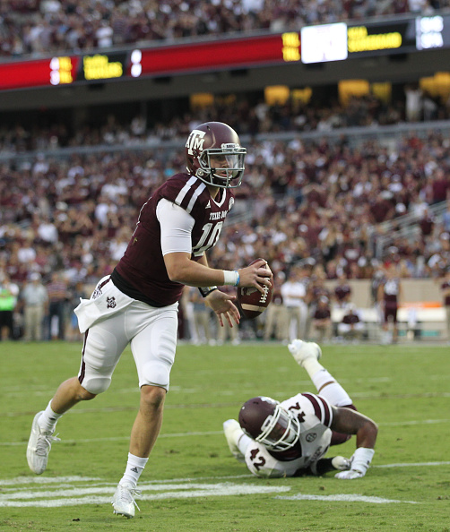 COLLEGE STATION TX- OCTOBER 03 Kyle Allen #10 of the Texas A&M Aggies avoids the tackle of Beniquez Brown #42 of the Mississippi State Bulldogs and throws a touchdown pass in the first quarter