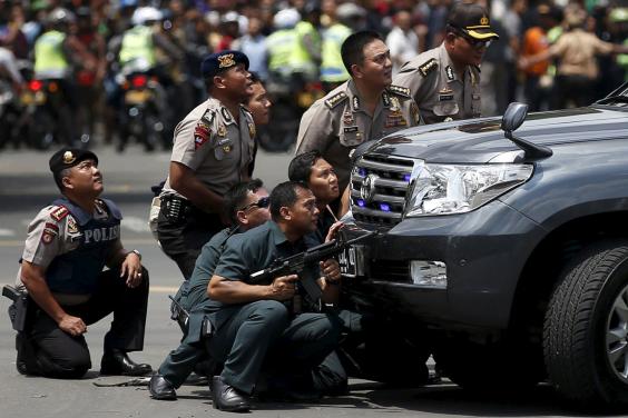 Police Officers react near the site of the blast in Jakarta Reuters