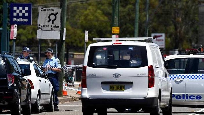 Police officers stand outside of the Quakers Hill Police Station in Sydney