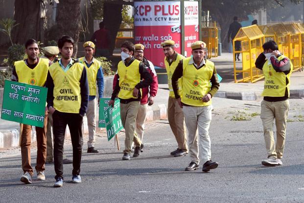 Civil Defence volunteers holding placards at ITO as Odd-even scheme restricting movement of private cars is operational in New Delhi on Saturday