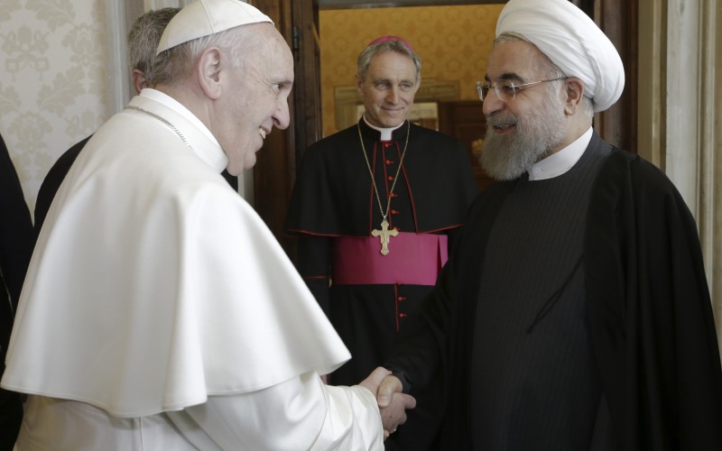 Pope Francis shakes hands with Iranian President Hassan Rouhani at the Vatican