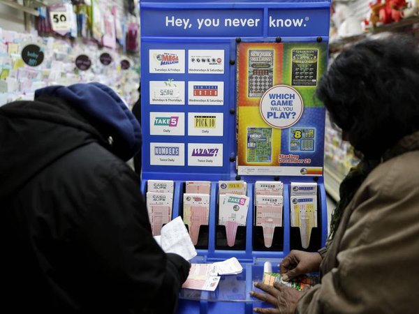 People play various lottery games at a store in New York Monday Jan. 11 2016. Lottery officials say the Powerball jackpot has grown to more than a billion dollars