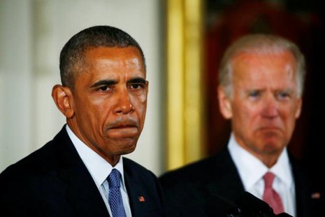 U.S. President Barack Obama stands with Vice President Joe Biden while delivering a statement on steps the administration is taking to reduce gun violence in the East Room of the White House in Washingt