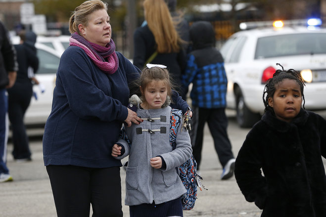 Students at Amy Beverland Elementary School are picked up after school after a bus accident in Indianapolis on Tuesday Jan. 26 2016. Authorities said an adult was killed and two children were seriously injured when a bus waiting outside the elementary