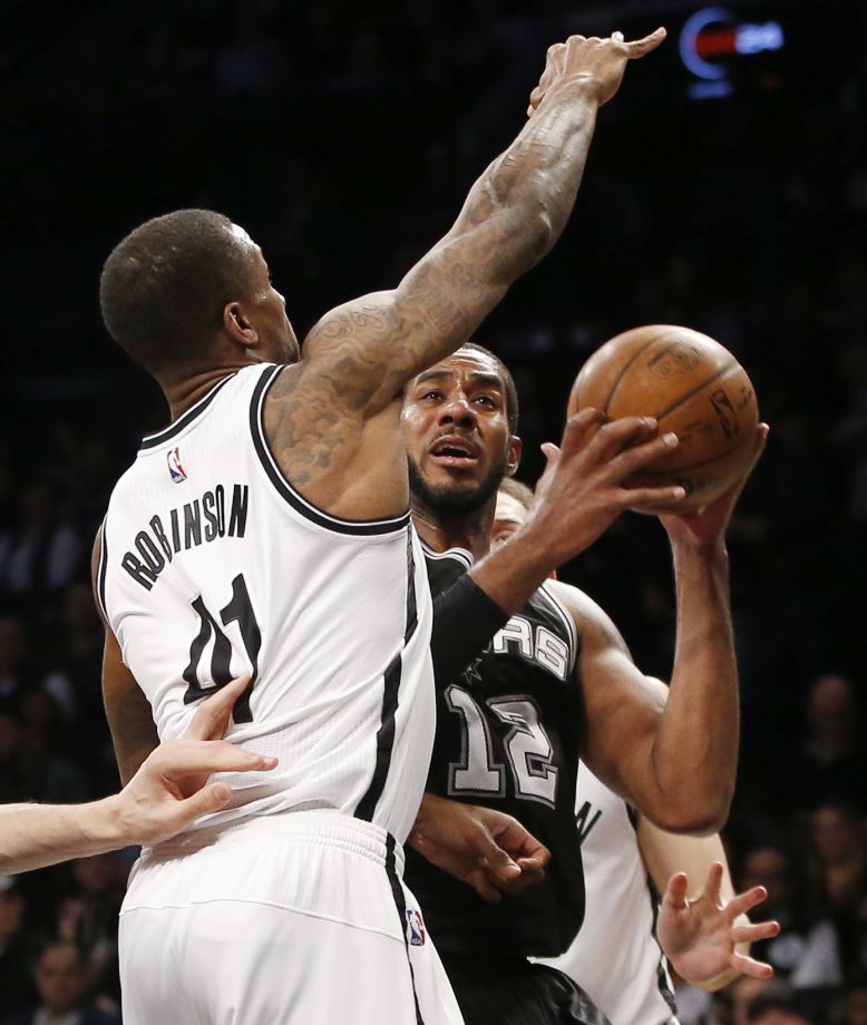 Brooklyn Nets forward Thomas Robinson defends San Antonio Spurs forward La Marcus Aldridge in the second half of an NBA basketball game Monday Jan. 11 2016 in New York. Aldridge had 25 points as the Spurs defeated the Nets 106-79. (AP