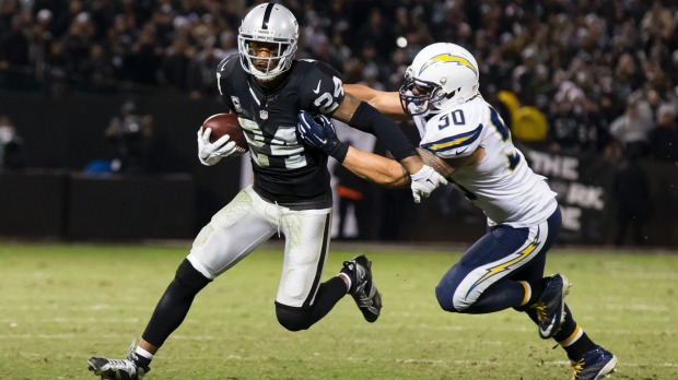 Oakland Raiders free safety Charles Woodson carries the ball against San Diego Chargers inside linebacker Manti Te'o