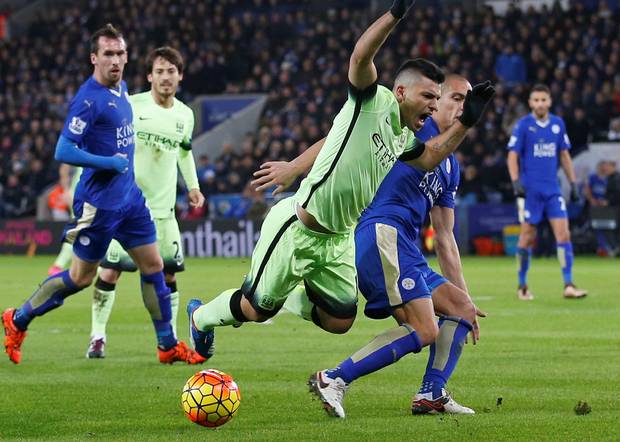 Manchester City’s Sergio Aguero is challenged in the penalty area by Gokhan Inler of Leicester City during the Premier League match at The King Power Stadium last night