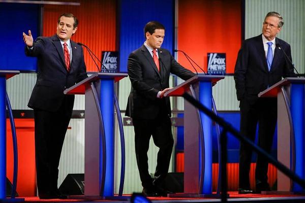 Sen. Ted Cruz R Texas, answers a question as Sen. Marco Rubio R-Fla. listens and former Florida Gov. Jeb Bush looks on during a Republican presidential primary debate Thursday Jan. 28 2016 in Des Moines Iowa. Charlie Neibergall  AP