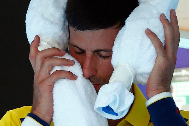 Serbia's Novak Djokovic places an ice pack on his head during a break in his first round match against South Korea's Hyeon Chung