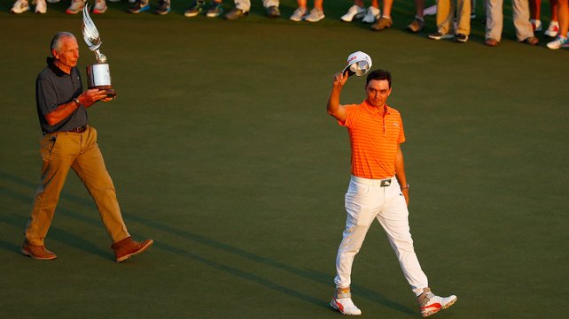 Rickie Fowler salutes the crowd after securing victory