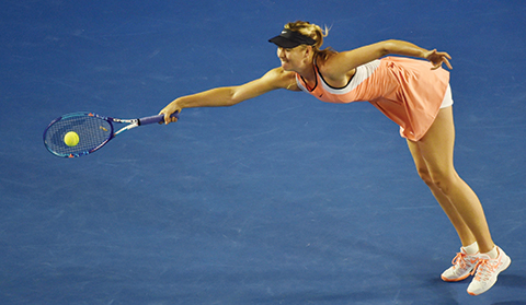 TOPSHOT- Russia's Maria Sharapova returns against Lauren Davis of the US during their men's singles match on day five of the 2016 Australian Open tennis tournament in Melbourne