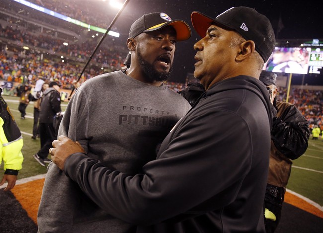 Pittsburgh Steelers head coach Mike Tomlin talks with Cincinnati Bengals head coach Marvin Lewis following an NFL wild-card playoff football game Sunday Jan. 10 2016 in Cincinnati. Pittsburgh won 18-16