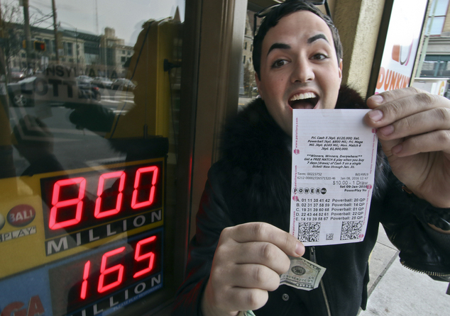 Brian Kenny of Scranton Pa. jokes outside City Market & Cafe as he displays a Powerball lottery ticket he bought Friday Jan. 8 2016. The record Powerball