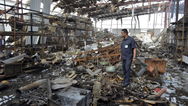 A worker stands at a beverages factory after it was hit by a Saudi-led air strike in Yemen's Red Sea port city of Houdieda