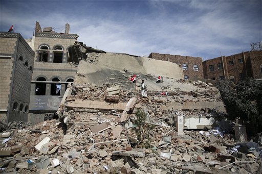 A man stands on the rubble of the Chamber of Trade and Industry headquarters after it was hit by a Saudi-led airstrike in Sanaa Yemen Tuesday Jan. 5 2016