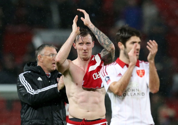 Sheffield United manager Nigel Adkins left Martyn Woolford centre and Ryan Flynn applaud the travelling fans after the final whistle