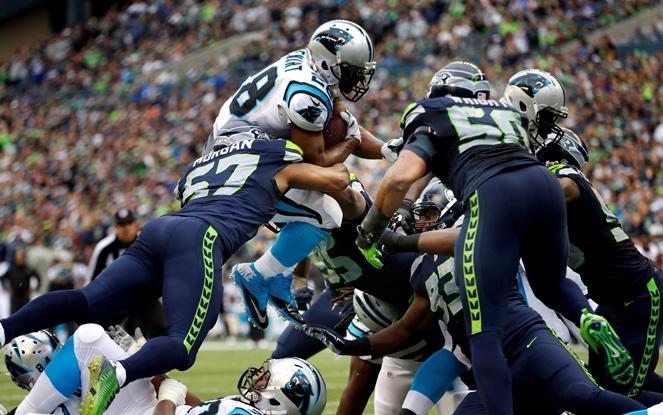 Carolina Panthers running back Jonathan Stewart top leaps over Seattle Seahawks outside linebacker Mike Morgan to score a touchdown in the second half of a game Sunday Oct. 18 2015 in Seattle. The Panthers won 27-23