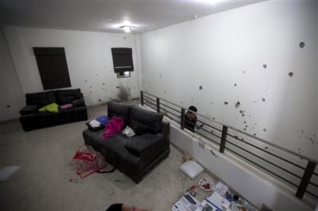 Bullet holes riddle the walls of the second floor of the home that marines raided in their search for Mexican drug lord Joaquin “El Chapo” Guzman in Los Mochis Mexico Monday Jan. 11 2016. On Friday Guzman and his security chief traveled several