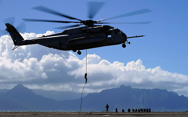 Members of the 2nd Battalion Princess Patricia's Canadian Light Infantry from Shilo Manitoba and 1st Battalion 3rd Marines from Hawaii United-States practice the Fast Rope Insertion Extraction System with a CH-53E Super Stallion helicopter at Marine