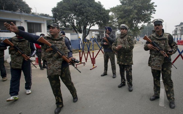 Security personnel stand guard inside the Indian Air Force base at Pathankot in Punjab